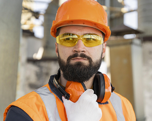 Ein Mann trägt Helm, Schutzbrille und Gehörschutz
